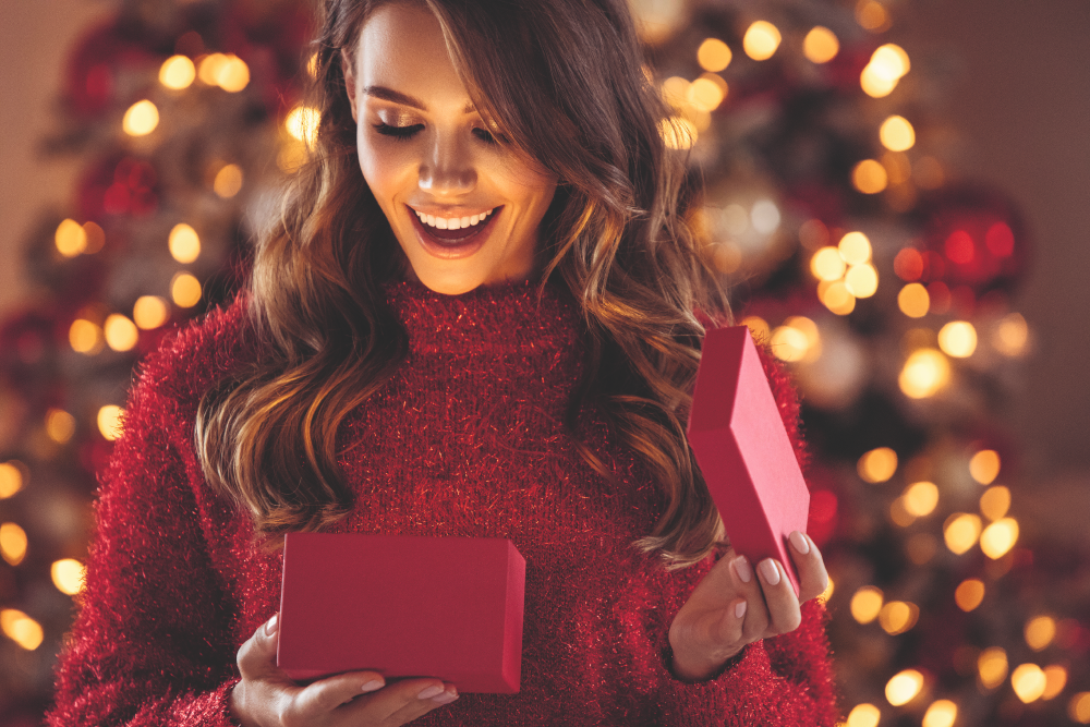 Women opening gift in cristmas lights